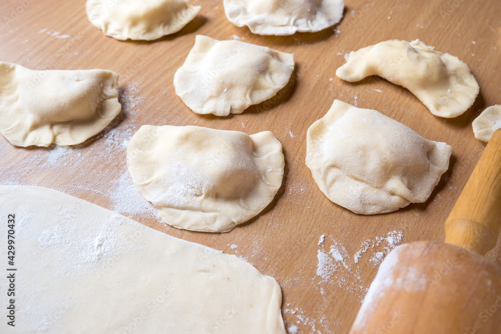 Raw dumplings on a board. Traditional homemade food Raw dumplings on a board. Traditional homemade food