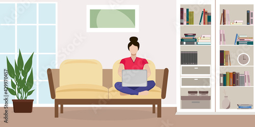 Working from home concept. Woman on the couch with a laptop. Living room interior with wardrobe, window, plant, books