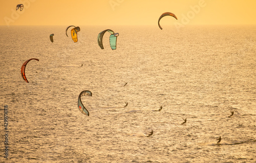 A view from above on kites and people kitesurfing.