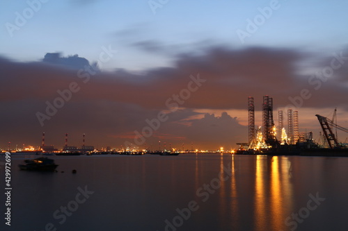 oil refinery at sunset, port, sea industry, sunset, clouds, water, sea view, evening sunset, night view, sea at night, 