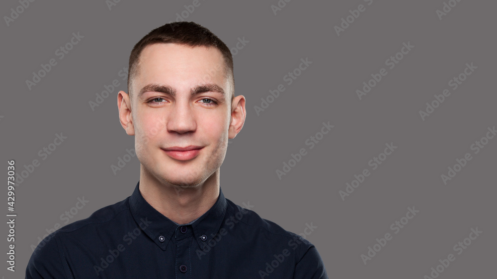 Young sincere man portrait isolated on gray background Young sincere man portrait isolated on gray background