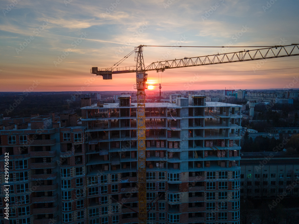 aerial view of apartment construction site with crane