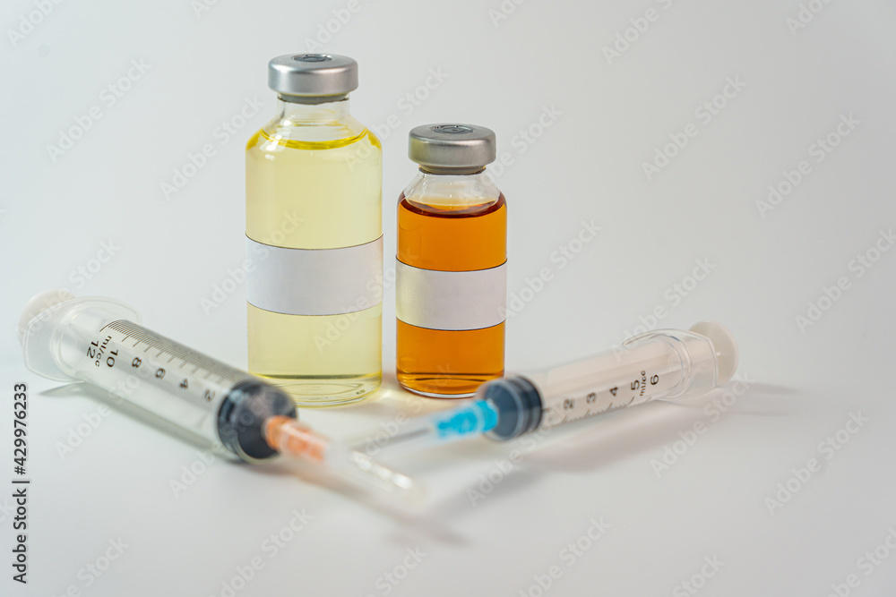 Vaccine bottles with white blank label and syringe injection Vaccine bottles with white blank label and syringe injection