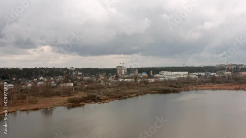 Wallpaper Mural Aerial wide view of cityscape with coastline on a cloudy day. Drone shot of urban background. Torontodigital.ca