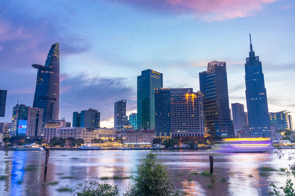 Fototapeta premium Bitexco Financial Tower building, buildings, roads and Saigon river in Ho Chi Minh city - This city is a popular tourist destination of Vietnam. Business and landscape concept.