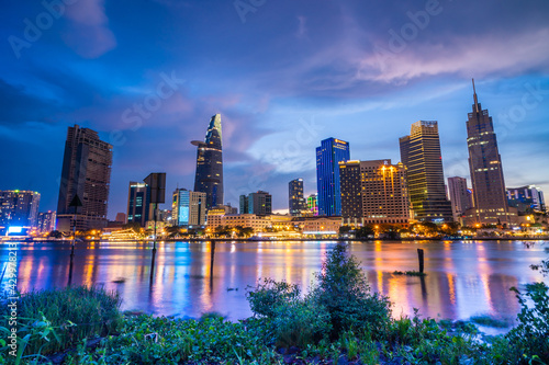 Bitexco Financial Tower building, buildings, roads and Saigon river in Ho Chi Minh city - This city is a popular tourist destination of Vietnam. Business and landscape concept.