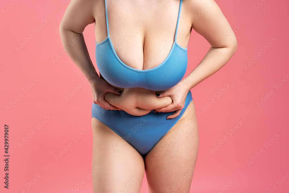 Fat woman with very large breasts in blue underwear on pink background,  body care concept Stock Photo | Adobe Stock
