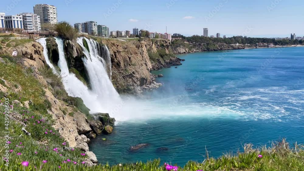 Lower Düden Falls drop off a rocky cliff falling from about 40 m into the Mediterranean Sea in amazing water clouds 4k footage. Antalya, Turkey. Lower Düden Falls drop off a rocky cliff falling from about 40 m into the Mediterranean Sea in amazing water clouds 4k footage. Antalya, Turkey.