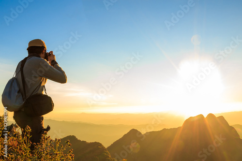 Photographer stand on the top of the mountain and shooting a photo on the top peak of mountain Chiangdao, at Chiangmai Thailand, Asia.