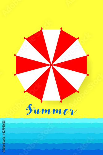 White and red beach umbrella against the backdrop of yellow sand and blue sea