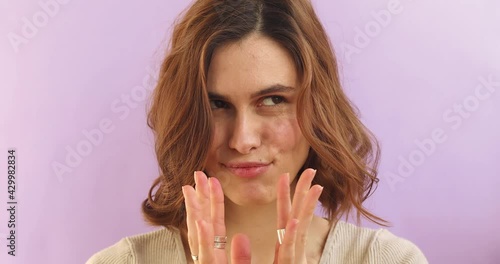 Mysterious sly woman steepls fingers and schemes something tries to made up mind makes devious tricky plan wears casual sweater isolated over violet background. Evil genius action.