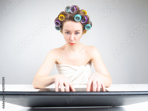 Curlers on a woman hair. Gi...