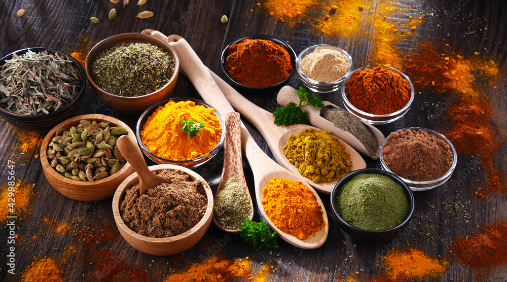 Variety of spices on wooden kitchen table. Variety of spices on wooden kitchen table.