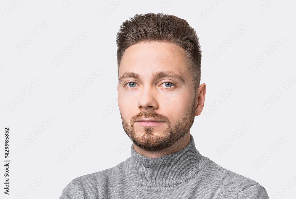 Closeup portrait of handsome serious young man, smiling joyful cheerful men studio shot. Isolated on gray background. Closeup portrait of handsome serious young man, smiling joyful cheerful men studio shot. Isolated on gray background.