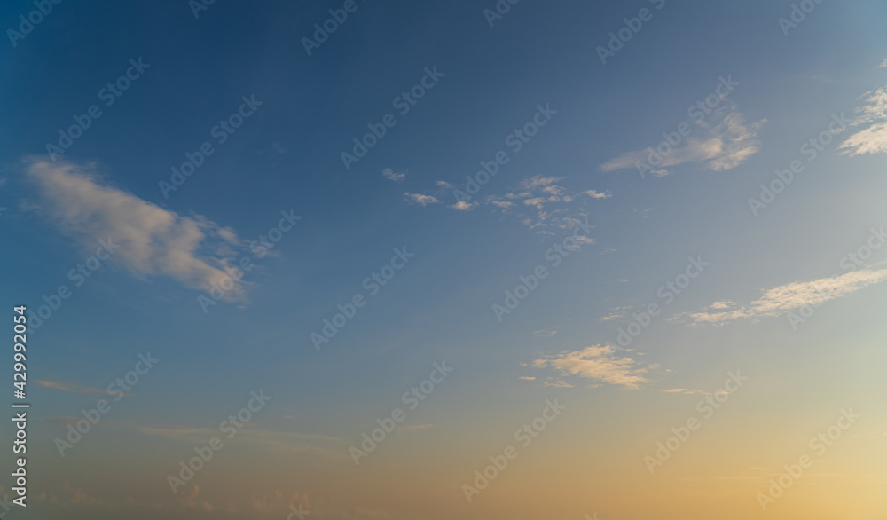 Morning sky with orange sunrise clouds and blue sky background 