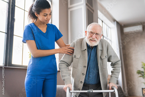 Obraz na płótnie Man using walker rehabilitation at home