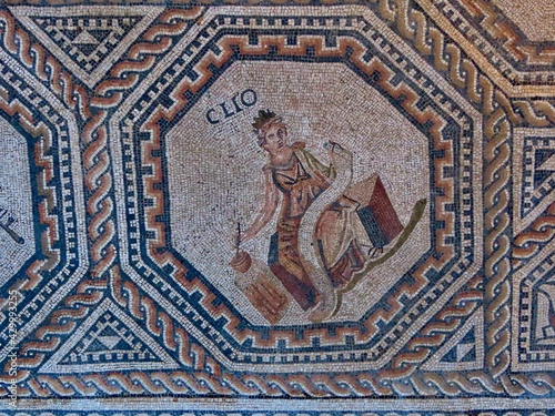 Clio - one of 9 muses portrayed in medalion with geometric ornamented borders. The Roman floor mosaic is freely accessible for everybody outdoors in Vitchen, Luxembourg