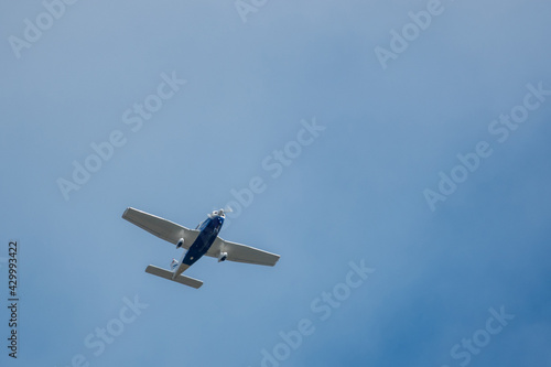  close up of a white flying propeller plane