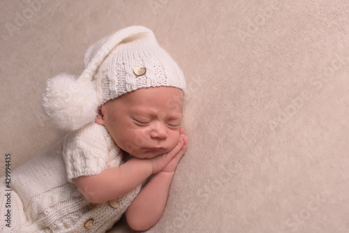 portrait of newborn baby with a white knitted. Healthy concept