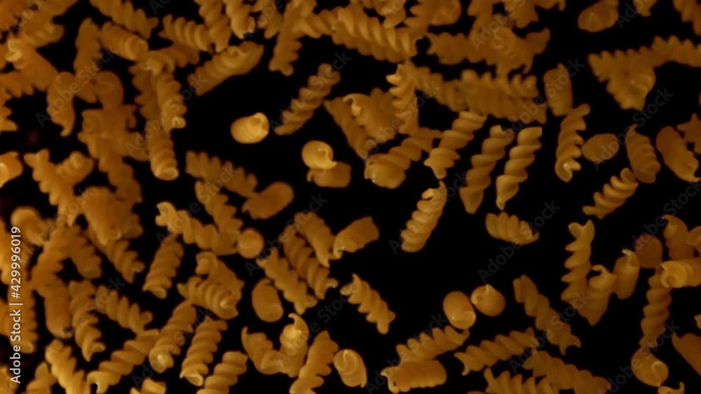 Super slow motion pasta fusilli dry. On a black background.Filmed on a high-speed camera at 1000 fps. High quality FullHD footage Super slow motion pasta fusilli dry. On a black background.Filmed on a high-speed camera at 1000 fps. High quality FullHD footage