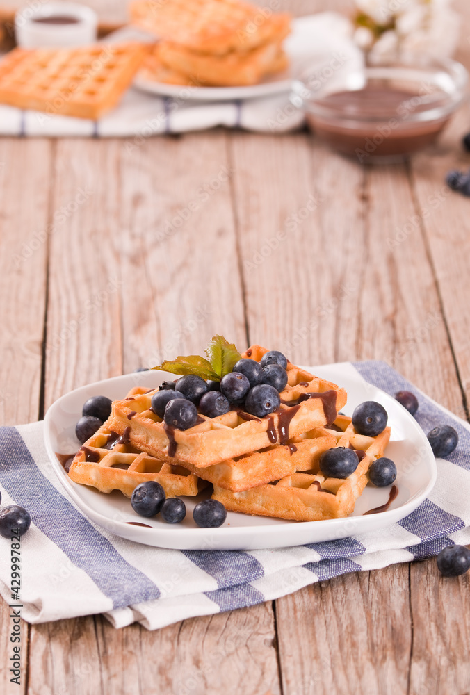 Fototapeta premium Waffles with blueberries and chocolate cream.