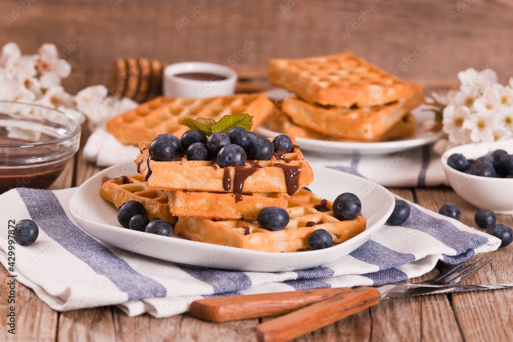 Waffles with blueberries and chocolate cream.