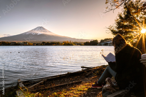 European tourists spend their free time To sit and read on the lake kawaguchiko Japan.