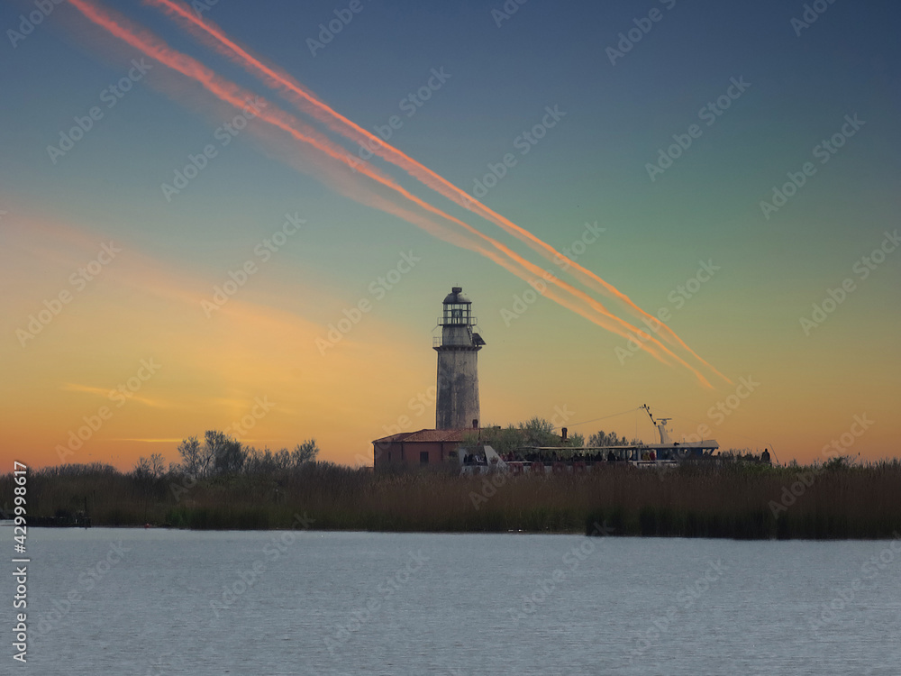 red sunset with lighthouse Valleys of Comacchio Ferrara with sunset and lighthouse