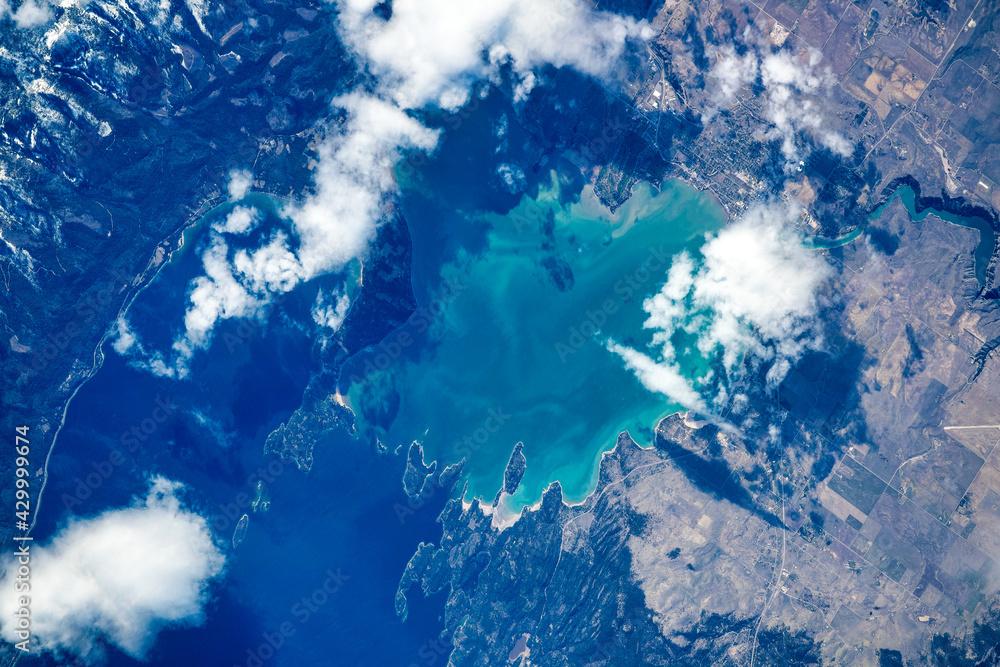 Aerial view of part of the United States. Digital enhancement by the artist. The ISS is flying from Oregon to Pasco. Elements of this image furnished by NASA. 