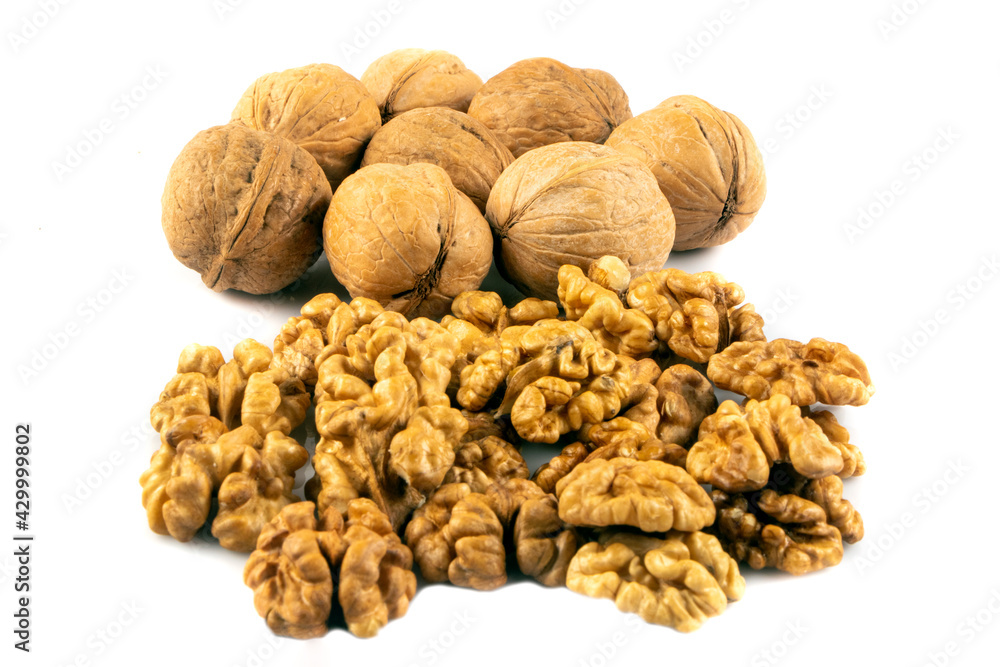 Delicious whole and broken walnuts isolated on white background. Whole and cracked walnut. Delicious whole and broken walnuts isolated on white background. Whole and cracked walnut.