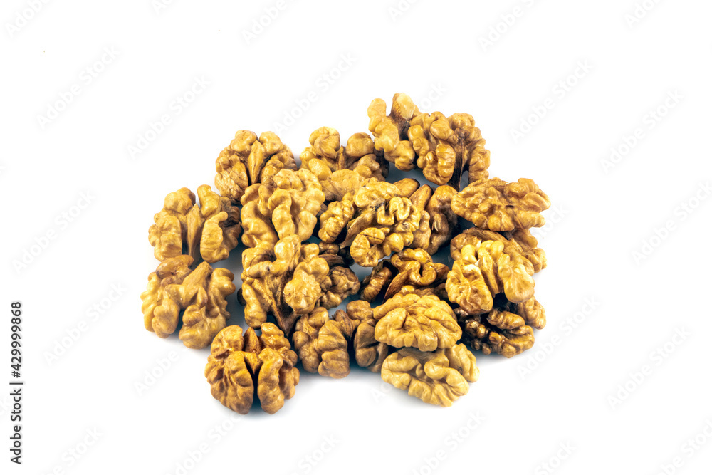 Delicious whole and broken walnuts isolated on white background. Whole and cracked walnut. Delicious whole and broken walnuts isolated on white background. Whole and cracked walnut.