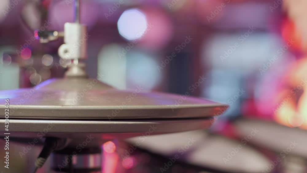 The drummer uses the cymbals of a drum kit while playing music, the close up. The drummer uses the cymbals of a drum kit while playing music, the close up.