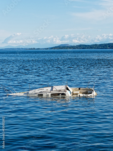 Sunken boat floats in the coastal waters near shore of Sidney BC © pr2is