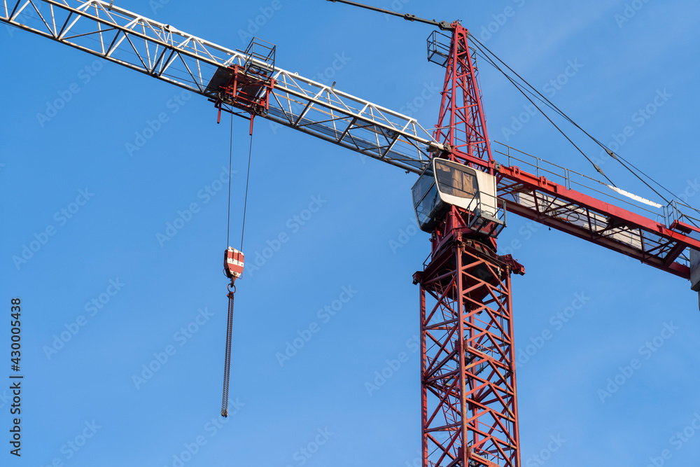 tower crane and protective screens around the building under construction technology