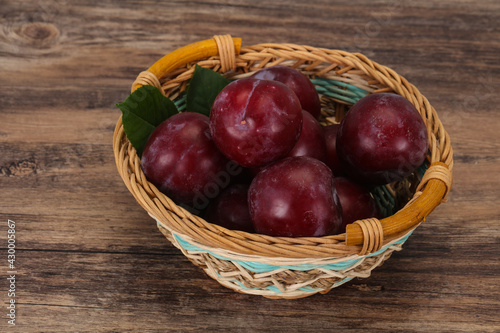 Plum heap in the wooden basket