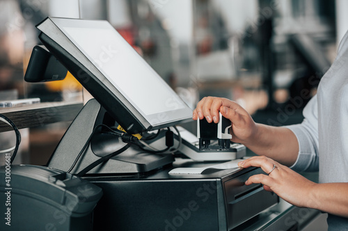 Close up of saleswoman hands accounting, billing some goods for sale, finance concept, getting a sale by stamp