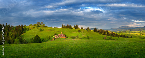 amazing view with high mountain village on horizon and blue cloudy sky. summer landscape. beautiful natural background