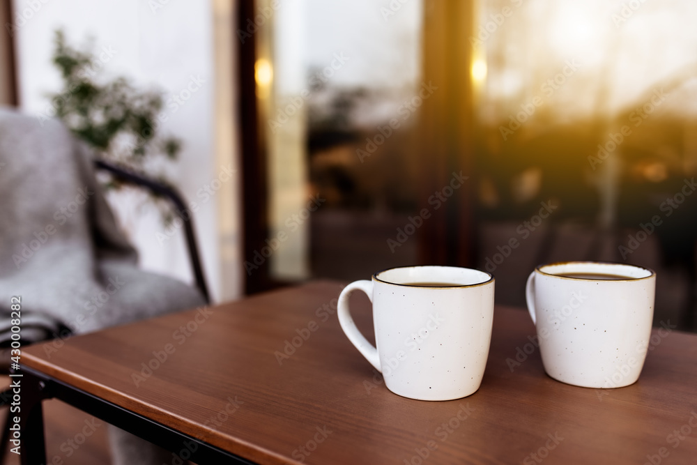 Two cups of coffee on the table on the wooden brown terrace Two cups of coffee on the table on the wooden brown terrace