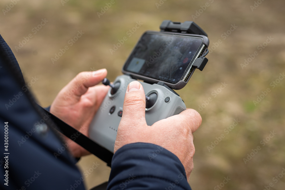 Hands in remote controller for drive a drone.