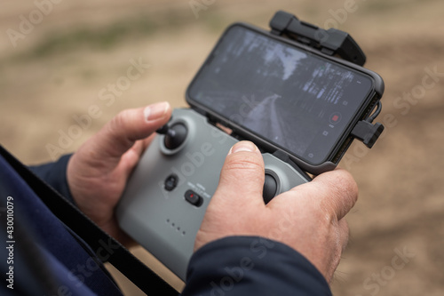 Hands in remote controller for drive a drone.