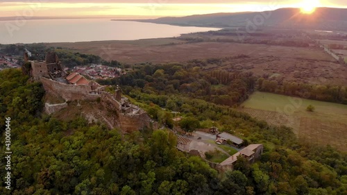 Aerial 4k drone view of the castle of Szigliget at sunset, a medieval fortress on a hill in Balaton Uplands, Hungary