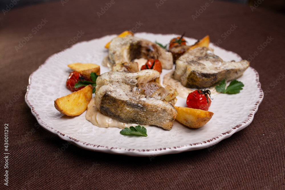 a dish of fish slices on white in a restaurant a dish of fish slices on white in a restaurant