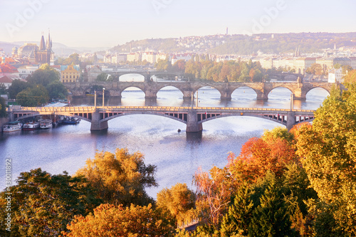 Prague in mist, six bridges on Vltava river in Prague, Czech Republic, on a misty morning in Autumn. Yellow, orange leaves on trees, romantic view.