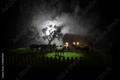 Sheep in the farm. Farm  village  life concept. Decorative toy figures at night. Selective focus