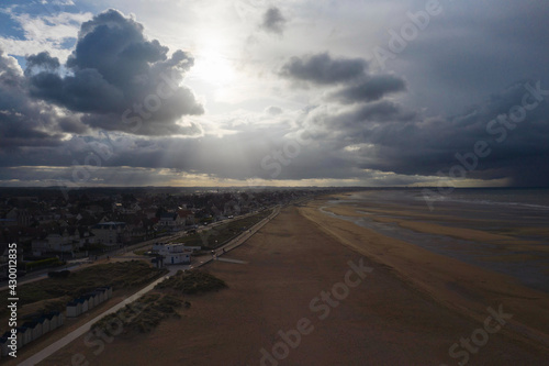 La plage de Sword beach à Ouistreham lors d'un orage au coucher du Soleil en France, en Normandie, dans le Calvados, au bord de la Manche.