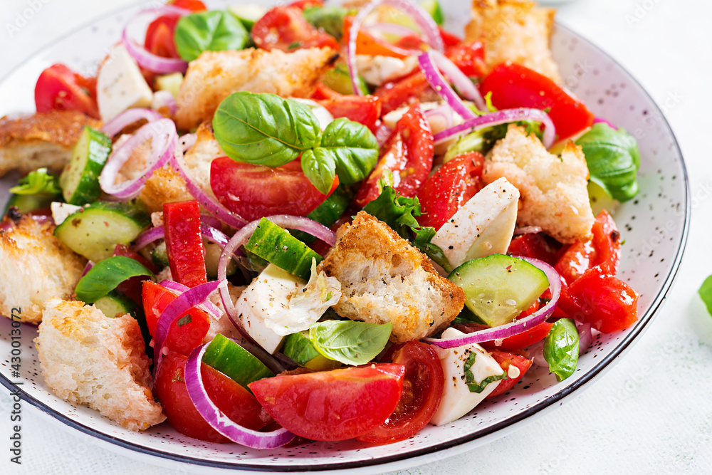 Traditional italian tomato salad panzanella with mozzarella, capers, red onion and croutons. Summer salad. Traditional italian tomato salad panzanella with mozzarella, capers, red onion and croutons. Summer salad.