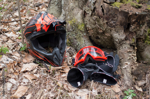 Black anf red helmet, goggles and motorcycle gloves photo