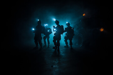 Anti-riot police give signal to be ready. Government power concept. Police in action. Smoke on a dark background with lights. Blue red flashing sirens. Dictatorship power
