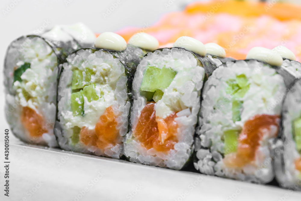 Sushi (a traditional dish of Japanese cuisine) on a white plate Sushi (a traditional dish of Japanese cuisine) on a white plate