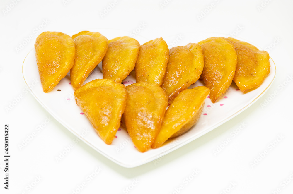 Qatayef Ramadan Or katayef Traditional Arabic Sweets cheese and brown Cinnamon sticks on white dish isolated on white background
Qatayef Ramadan Or katayef Traditional Arabic Sweets cheese and brown Cinnamon sticks on white dish isolated on white background